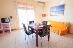 a dining room with a table and chairs and a couch at Ypsipyli in Mirina