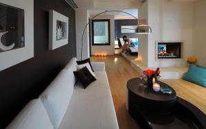 a living room with a white couch and a table at Iakovakis Suites & Spa in Koropi