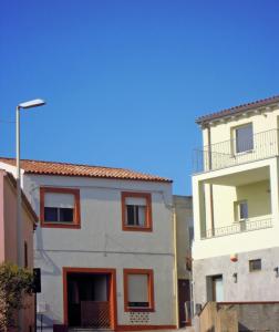 two buildings next to each other on a street at Maisonette Asfodelo in Palau