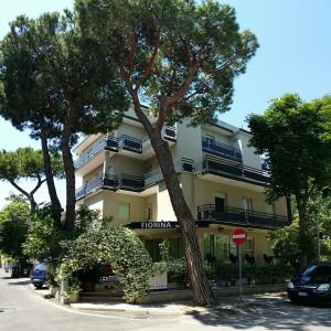 a building with a tree in front of it at Fiorina Bed&Breakfast - Colazione fino a mezzogiorno - Beach Village gratuito - Aquafan 25e - Oltremare 22e in Riccione