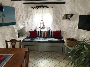 a living room with a couch with pillows on it at Finca Antigua in Las Breñas