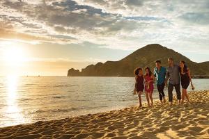 a family walking on the beach at sunset at Breathless Cabo San Lucas - Adults Only in Cabo San Lucas
