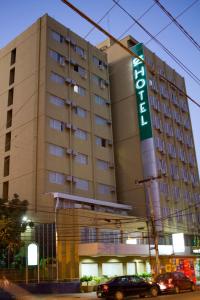 a large building with a sign on the side of it at Oft San Conrado Hotel in Goiânia