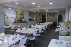 a large room with tables, chairs, and tables in it at Oft San Conrado Hotel in Goiânia