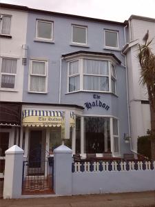 a blue building with a white fence in front of it at The Haldon Guest House in Paignton