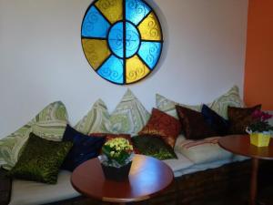 a couch with pillows and a stained glass window at Viverdi Hotel in Arujá