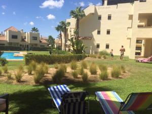 un hombre y un niño parados en un patio al lado de un edificio en Casa Rosie, en Los Alcázares