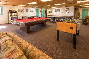 a room with couches and pool tables in a room at White Stallion Ranch in Marana