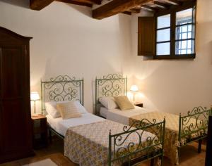 a bedroom with two beds and a window at Vitabella Toscana in Seggiano +155 photos