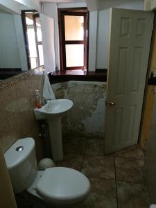 a bathroom with a toilet and a sink at Casa Jocotenango in Guatemala