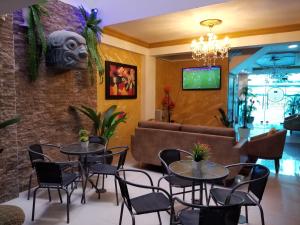 a restaurant with tables and chairs and a couch at Imperio Tanpu Q in Lima