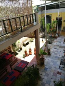 an open courtyard with potted plants and a balcony at Casa Jocotenango in Guatemala