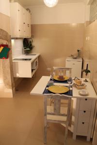a kitchen with a table with chairs and a refrigerator at Casa d Sintra in Sintra