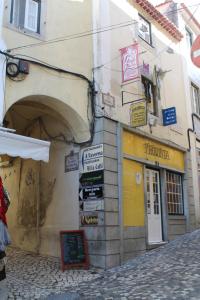 a building with signs on the side of a street at Casa d Sintra in Sintra