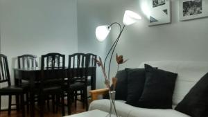 a living room with a couch and a table with a lamp at Apartamento Recoleta in Buenos Aires