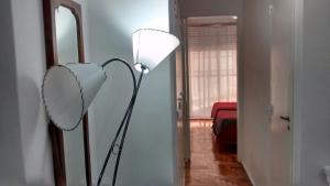 a lamp in a room with a mirror and a hallway at Apartamento Recoleta in Buenos Aires