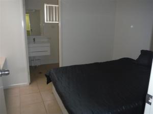a bedroom with a bed and a dresser at Units 37 on St Francis Drive in Moranbah