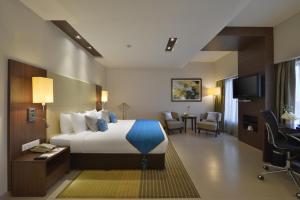 Postel nebo postele na pokoji v ubytování Grand Mercure Vadodara Surya Palace