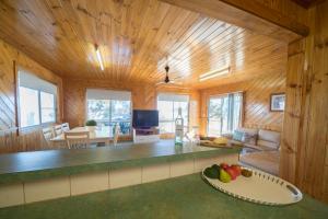 a kitchen and living room in a log cabin at Mundic Waterfront Cottages in Renmark