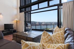 een woonkamer met een bank en een groot raam bij Point Waterfront Apartments in Durban