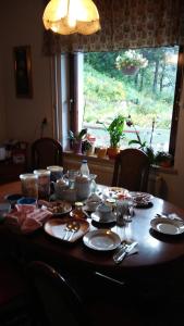 a table with plates and dishes on top of it at Apartment Žvan in Bohinj