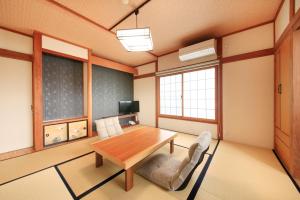 a living room with a wooden table and chairs at Hotel Togariishi in Chino +29 photos