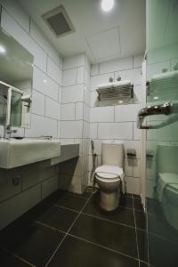a bathroom with a toilet and a sink at RHR Hotel - Selayang in Batu Caves