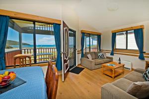 a living room with a view of the ocean at Acclaim Rose Gardens Beachside Holiday Park in Albany