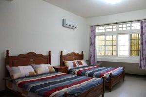 Postel nebo postele na pokoji v ubytování Xiang Pin Yuan Homestay