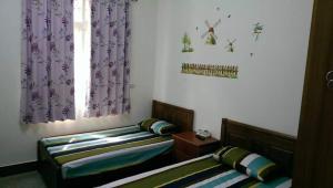 Postel nebo postele na pokoji v ubytování Xiang Pin Yuan Homestay