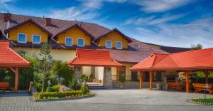 a house with orange roofs and a patio at Hotel nad Rabą - Bochnia in Bochnia
