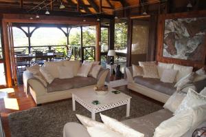 a living room filled with couches and a table at House 37 Nkululeko in Sodwana Bay Lodge - no loadshedding in Sodwana Bay