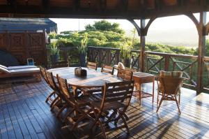 a wooden table and chairs on a patio at House 37 Nkululeko in Sodwana Bay Lodge - no loadshedding in Sodwana Bay