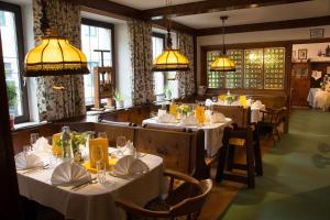 a dining room with tables and chairs and lights at Gasthof Manner in Perg