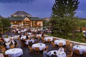 a group of people sitting at tables at a restaurant at Michlifen Resort & Golf in Ifrane