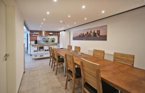 a dining room with a large wooden table and chairs at Loft-Unterkunft in Sinsheim