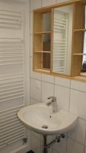 a bathroom with a white sink and a mirror at Übernachten im ehemaligen Zollgebäude in Hauset +5 photos