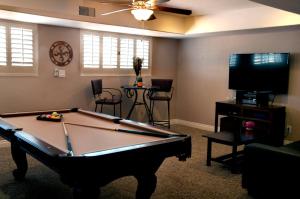 a living room with a pool table and a tv at Casa Saguaro Home in Cave Creek