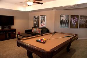 a living room with a pool table and a couch at Casa Saguaro Home in Cave Creek