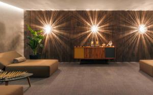 a lobby with a table and a couch and lights at Sir Anthony in Playa de las Americas