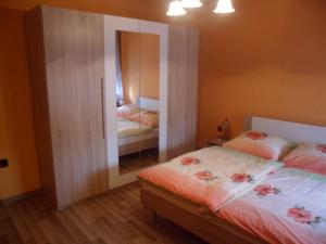 A bed or beds in a room at Liget Vendégház
