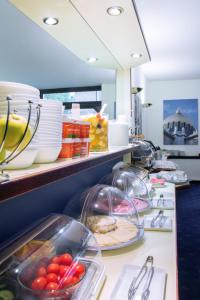 a kitchen counter filled with fruits and vegetables at Pension Pharmador in Vienna
