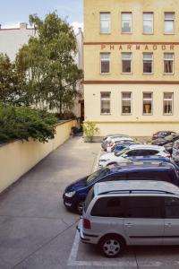 a car parked in front of a building with a lot of windows at Pension Pharmador in Vienna