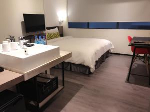 Postel nebo postele na pokoji v ubytování Goldinn Hotel