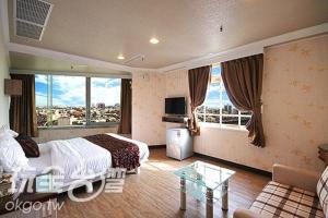 a hotel room with a bed and a view of a city at Ya Tai Hotel in Nanzi