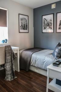 a small bedroom with a bed and a desk at Ludwina House in Birmingham