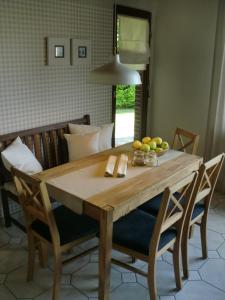 a dining room table with a bowl of fruit on it at Baltrumweg 4 in Wangerland