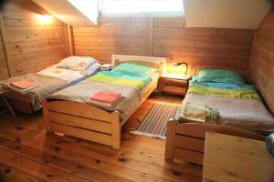 a room with three beds in a cabin at Gospodarstwo Agroturystyczne Stary Młyn Wilczkowice in Michałowice