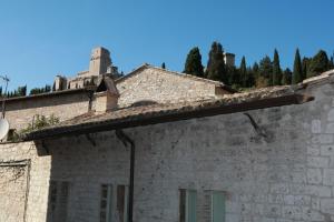 an old stone building with a castle on the roof at Palazzo Minciotti Assisi in Assisi