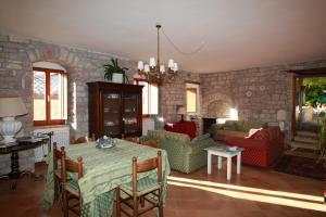 a living room with a table and a stone wall at Palazzo Minciotti Assisi in Assisi